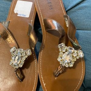 Guess Rhinestone bronze flip flops. 9M